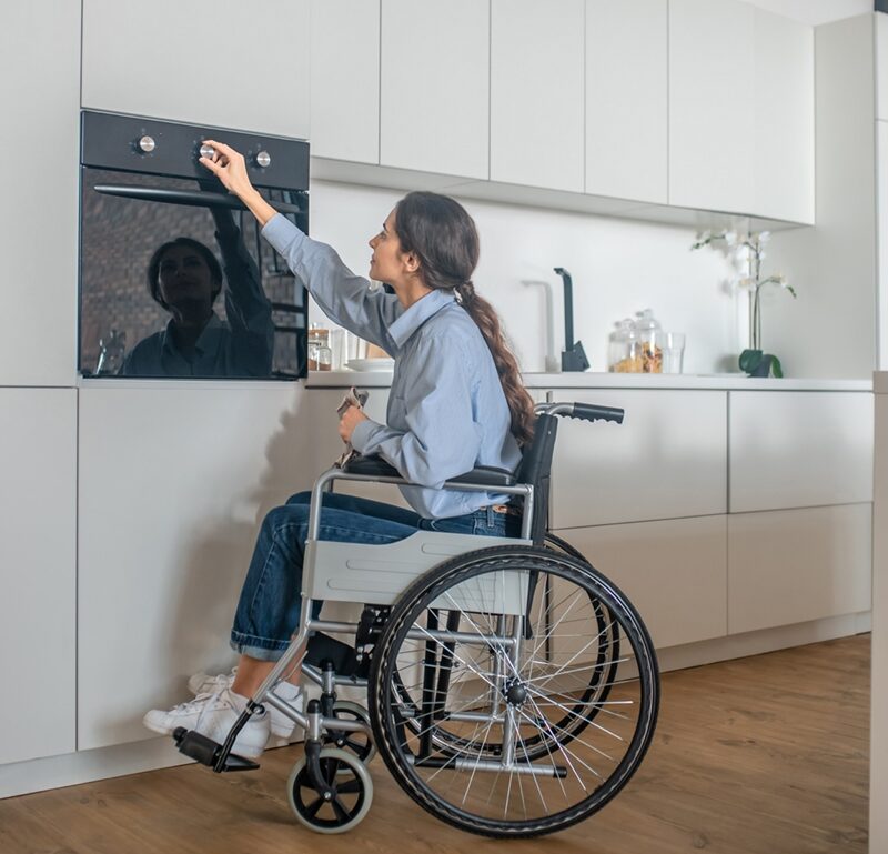 Barrierefreiheit - Frau im Rollstuhl in Küche